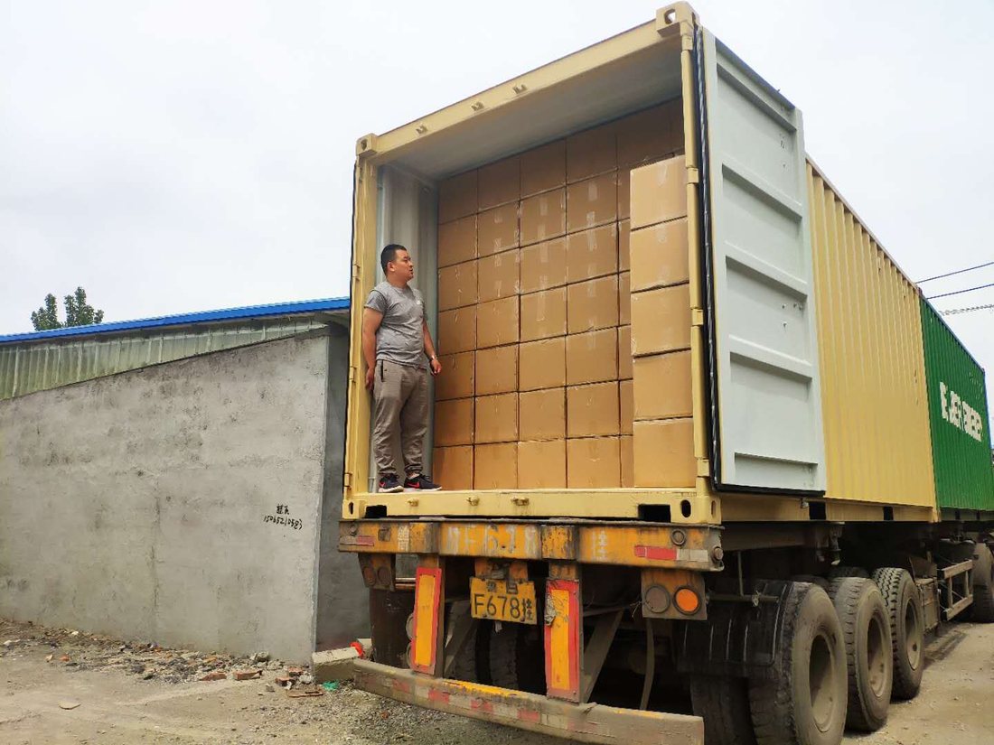 Elijah with a loaded shipping container of Bubzi Co stock